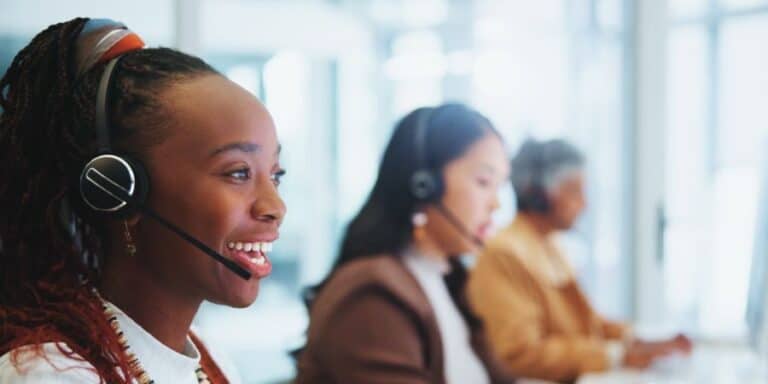 Woman who is conducting a CATI interview smiling.