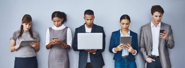 5 people standing in line using various types of technology