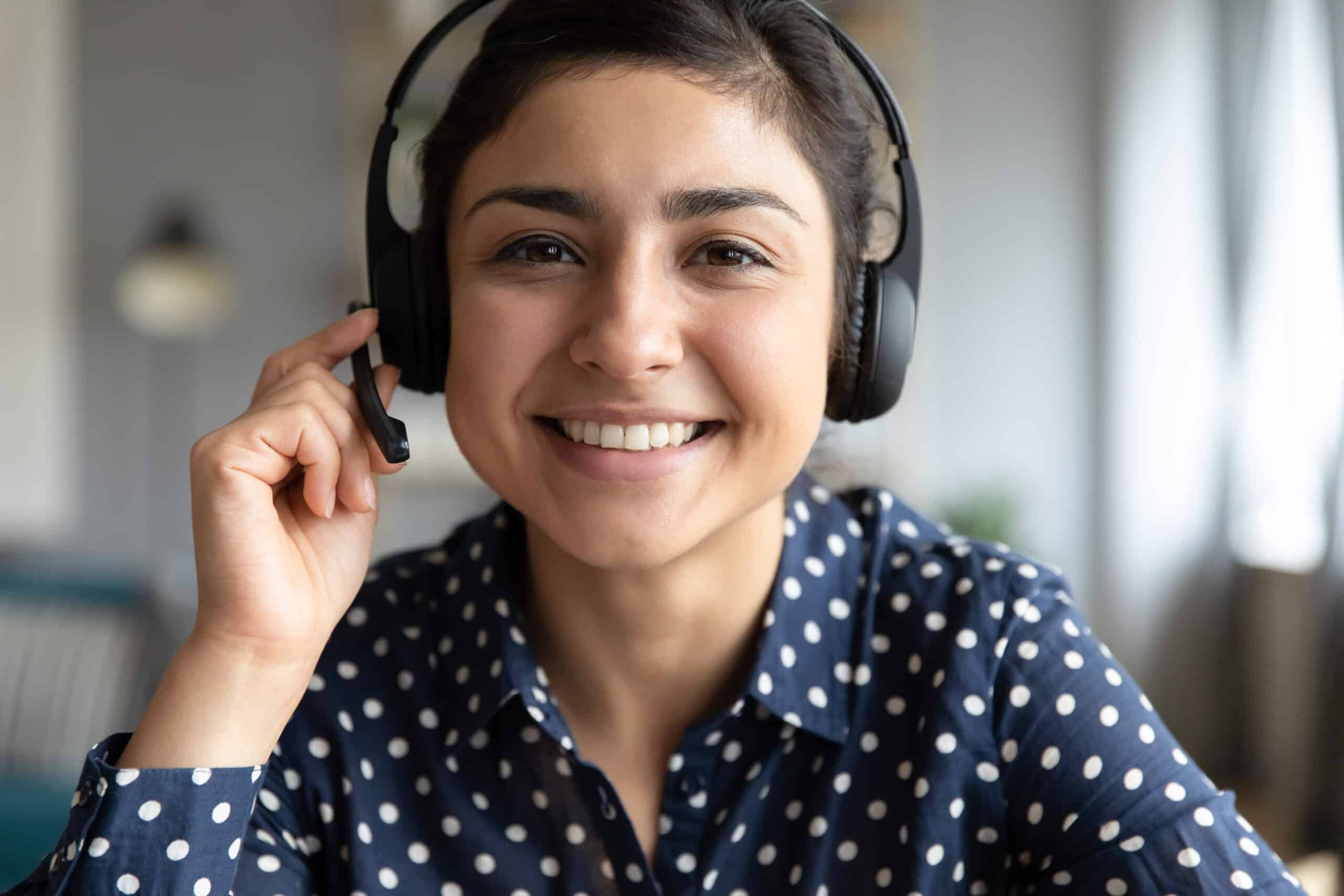 Young female simultaneous translator working with headset and microphone