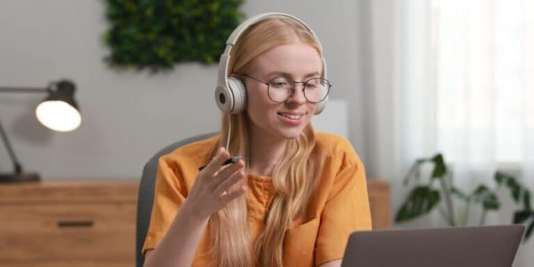 A woman wearing headphone translating an online interview
