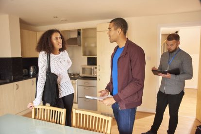 Young couple with estate agent looking around a rental flat