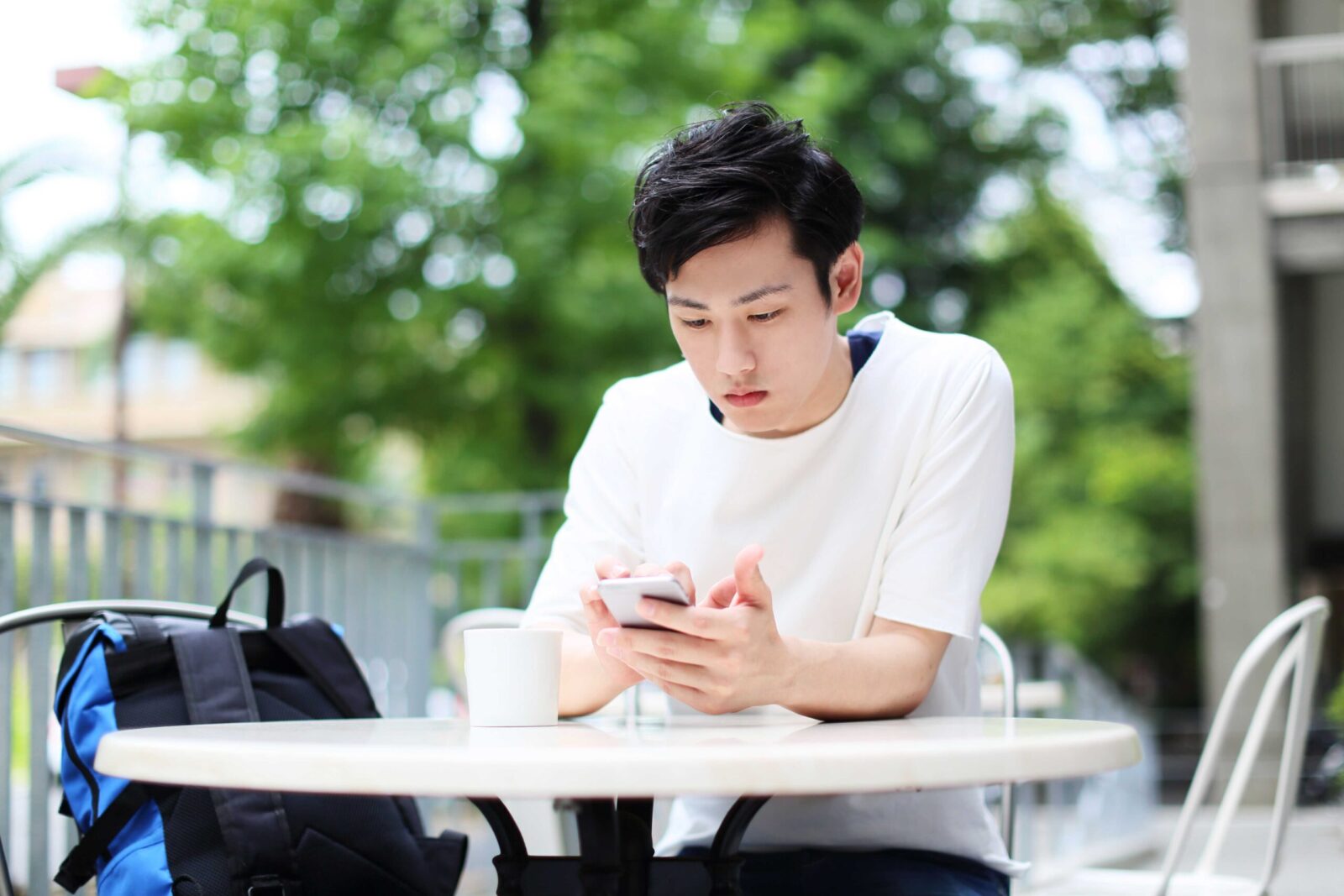 University student using a smartphone during a break