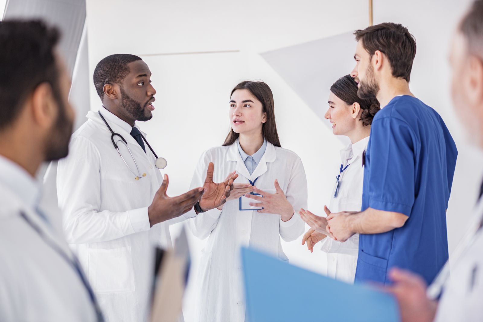 Hospital doctor talking to a small group of colleagues