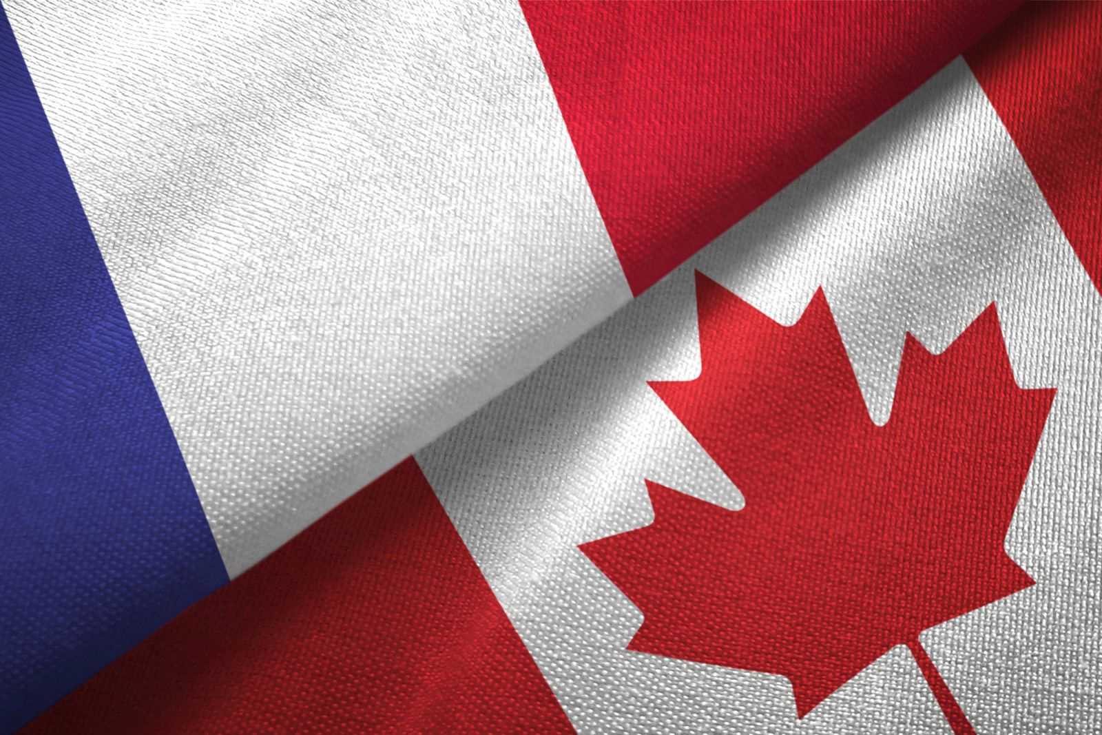 French-Canadian concept: French and Canadian flags draped on a tabletop