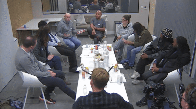 focus group with diverse participants in research facility discussing vitamin packaging