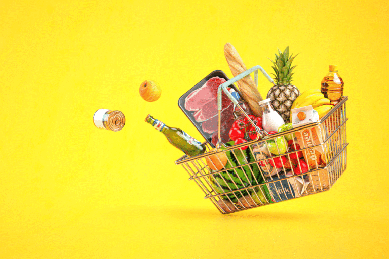 Accompanied shopping concept - a shopping basked full of groceries against a bright yellow background