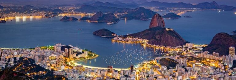 Rio de Janeiro, Brazil - aerial view at night. The famous Sugar Loaf mountain sticks out of Guanabara Bay