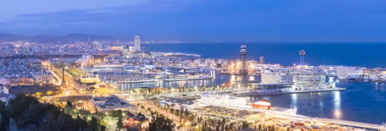 Barcelona, Spain - view over the city at night showing the port area and waterfront