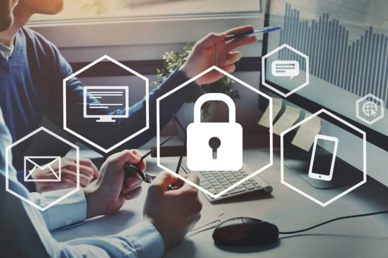 Two business people looking at a computer screen with privacy icons overlaid