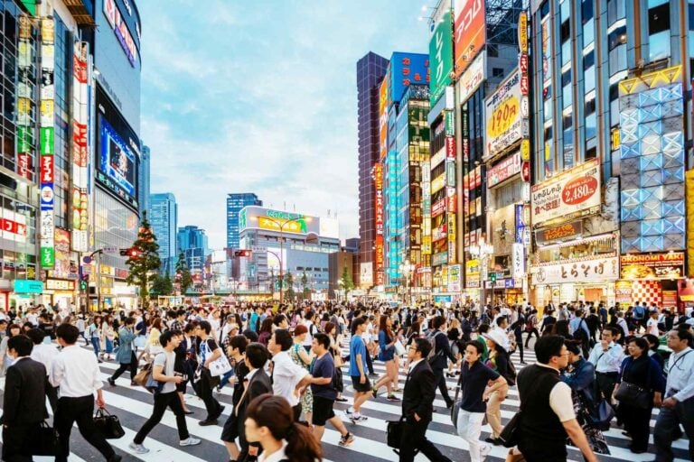 Pedestrian crossing in Shinjuku, Tokyo at sunset