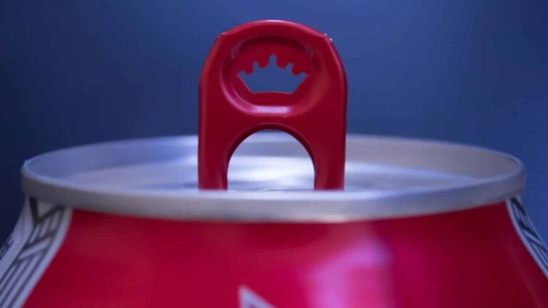 close up of open can of beer or soda at a taste testing