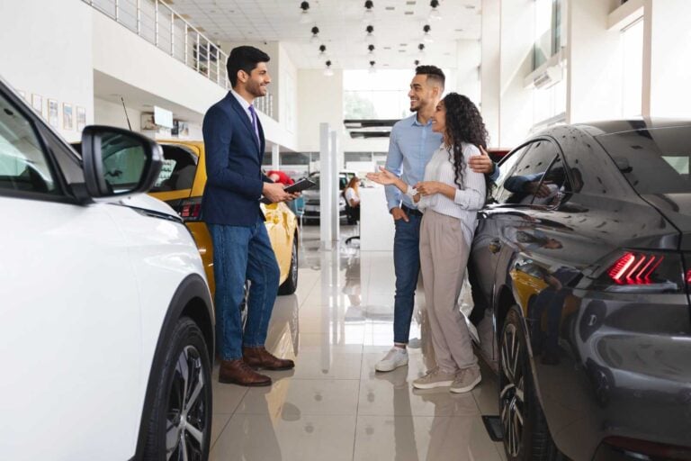 customers talking to salesperson in the middle east in a car dealership