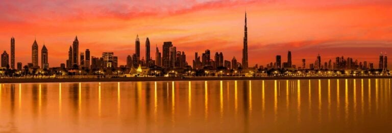 Dubai, UAE - panoramic view of Dubai Business bay at sunrise with the Burj Khalifa visible on the right