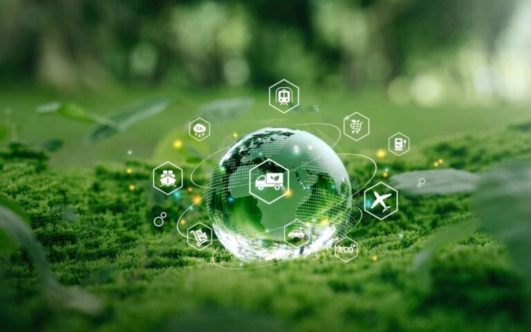 Environment and sustainability concept - glass globe standing on green moss with icons relating to sustainability