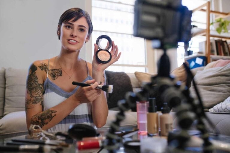 female short form video creator filming online post about trialling different make-up brands