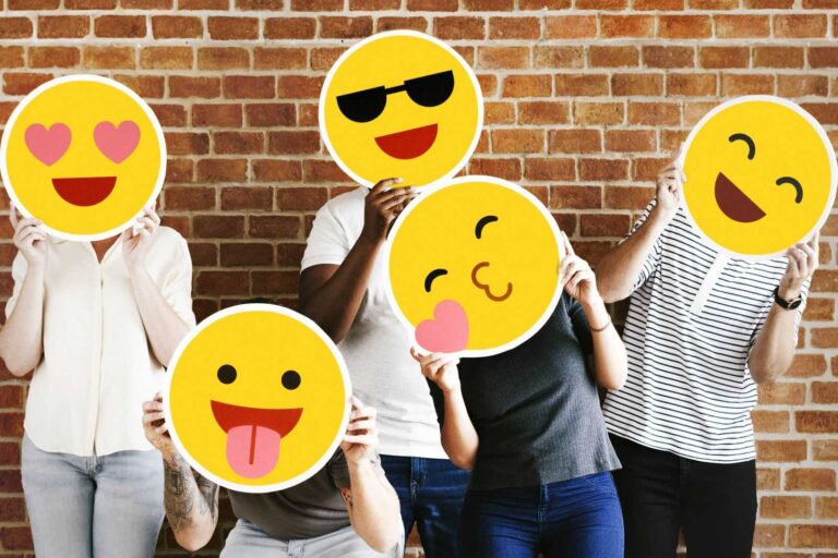 People holding positive emoticons posing infront of wall