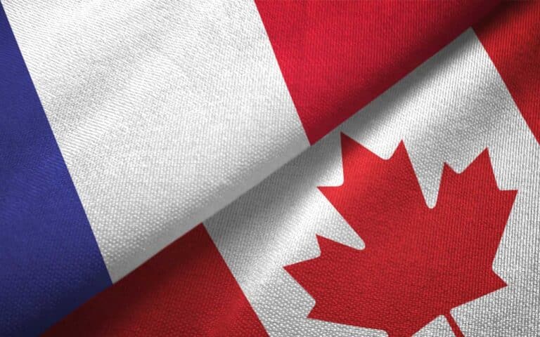 French and Canadian flags daraped on a tabletop