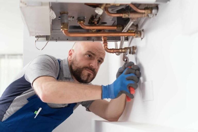 Gas engineer installing a new boiler in a customer's home