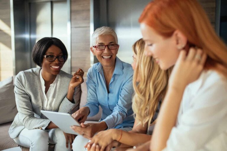 businesswomen working together on a tablet discussing franchise plans for their business