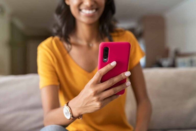 Young Indian woman using her smartphone and looking at screen
