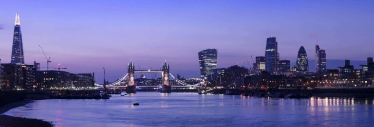 London, UK - panoramic view of the City and Southwark at duskfrom the River Thames with Tower Bridge visible in the centre and skyscrapers on both banks