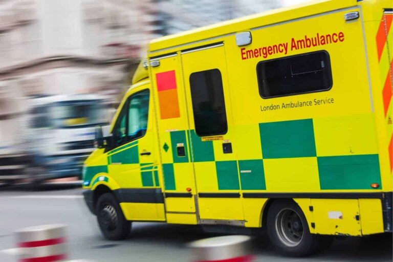 london emergency ambulance driving along busy street responding to 999 call