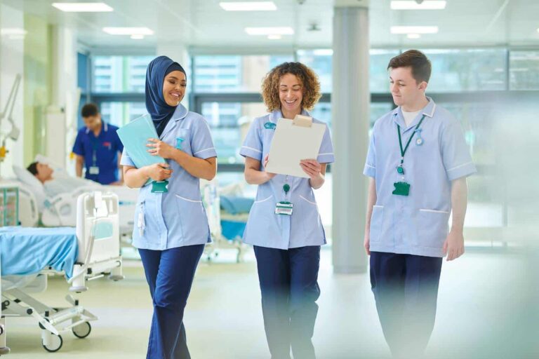 Three nurses talking while on a hospital round
