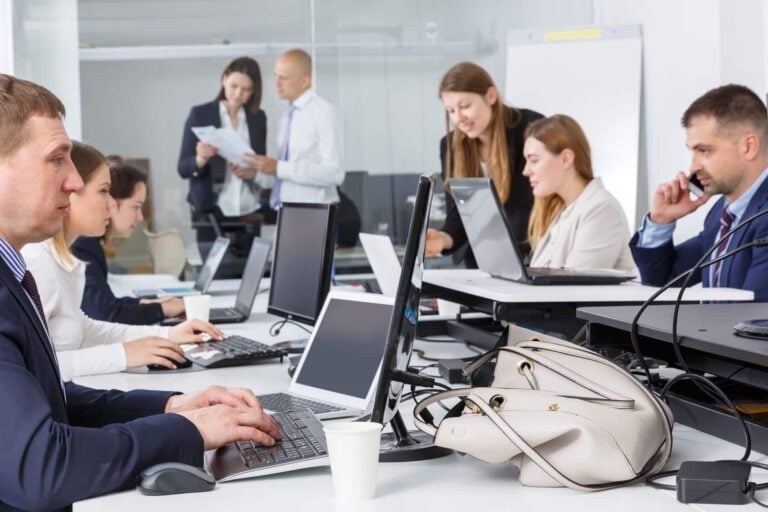 Males and females working together in a busy newspaper newsroom