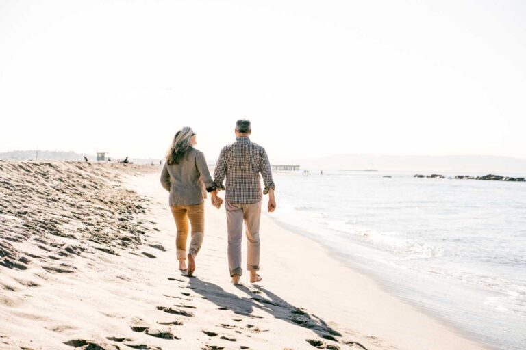 Active retired seniors on the beach together planning their retirement