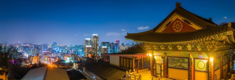 Seoul, South Korea - cityscape at night. Daeseongsa Temple on Mount Umyeonsan is illuminated in the foreground and many skyscrapers can be seen in the background