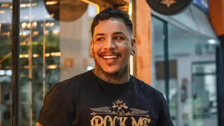 Young man with tattoos taking part in a vox pop rcording outside a shop