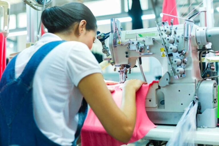 Woman using an industrial seiwing machine in a garment factory