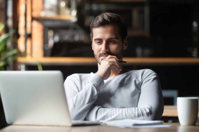 Young researcher sits at his desk puzzling over how to write a screener