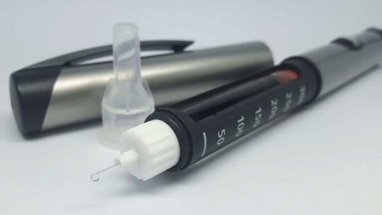 diabetic patient black insulin pen on gray background