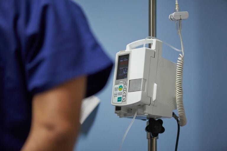 infusion pump with nurse checking readings in a hospital