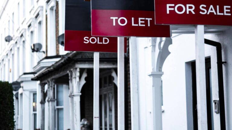 Estate agent signs labelled "for sale", "to let" and "sold" outside London homes