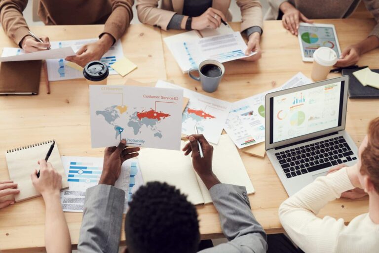 People sitting round a table discussing market research results