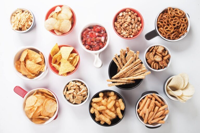 selection of salty snacks placed in graze bowls on white table