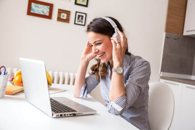 Young woman taking part in an online focus group while sitting in her kitchen