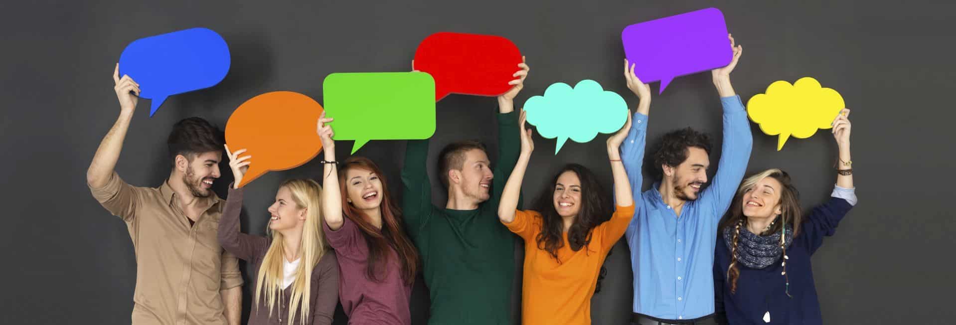 Young people holding up speech bubbles to represent case studies