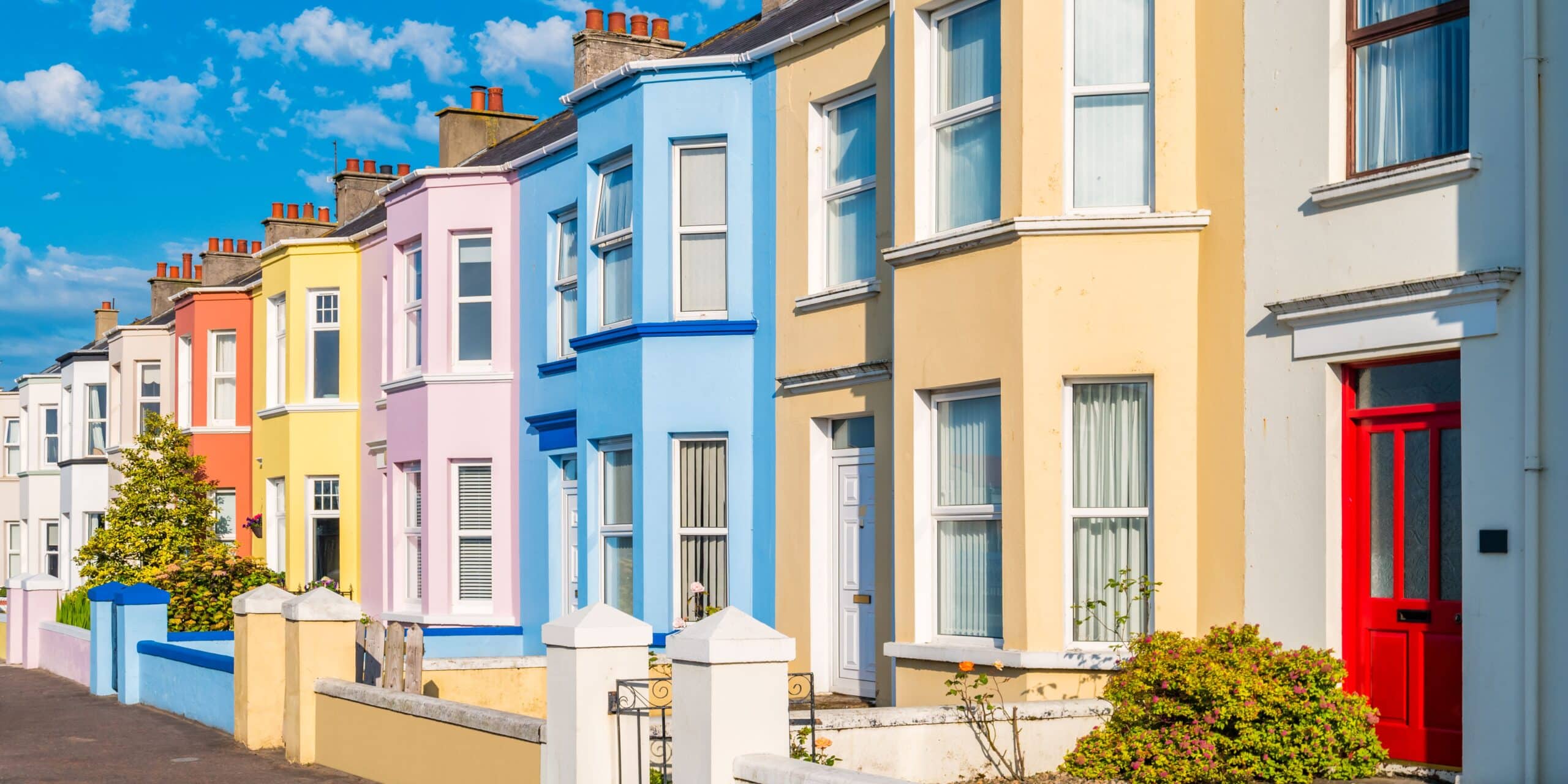 A row of brightly coloured terraced houses in the UK