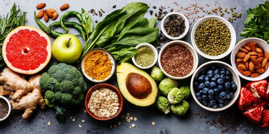 A variety of different fruits, vegetables and grains laid out on a table