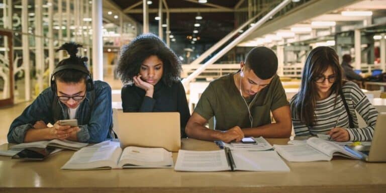 Male and female students studying in a college library