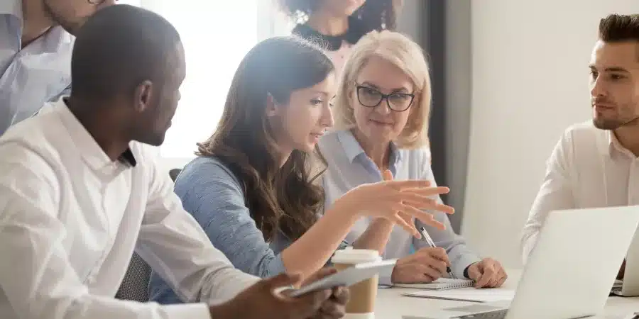 Discussion guide design and review - a qualitative moderator listens to a group a clients explaining their research objectives