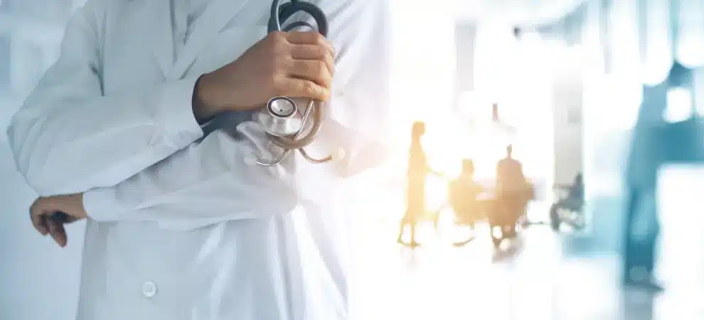 Heathcare market research concept - Doctor with stethoscope stands in hospital reception area
