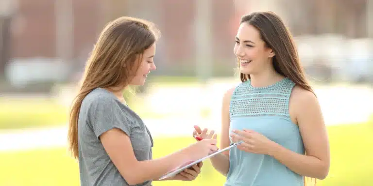 Female interviewer conducting intercept interviews at outdoor location
