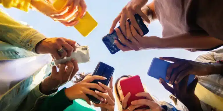 Market research online community - group of young people using their smartphones