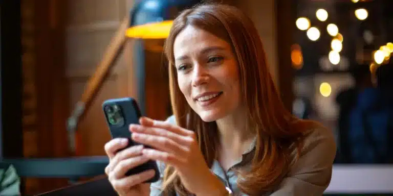Young woman completing an online survey at home on her smartphone