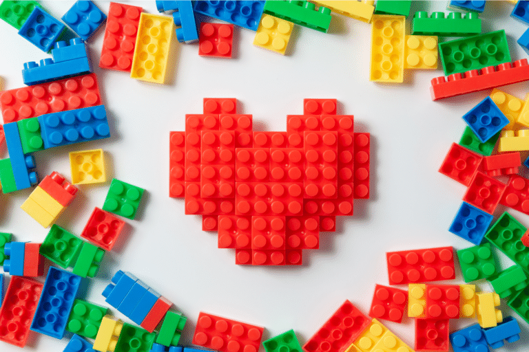pile of multi-coloured brick construction toy pieces in heart shape
