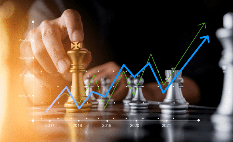 Concept of decision making - a man deciding where to move a piece on a chessboard overlaid with a revenue or profit graph